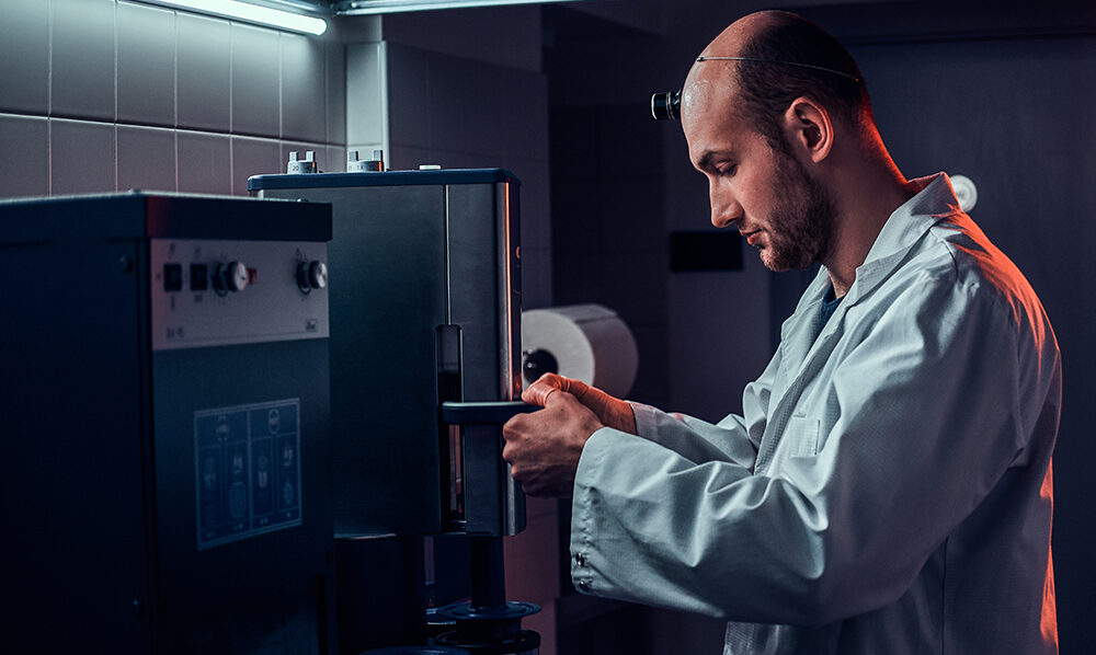 Expirienced watchmaker is working with autoclave at his own studio.